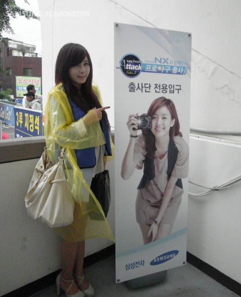 출사단 전용입구 앞에서 우비를 입은 모델