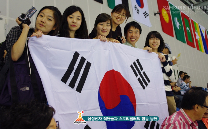 삼성전자 직원들과 스토리텔러들이 태극기를 들고 응원하고 있는 모습