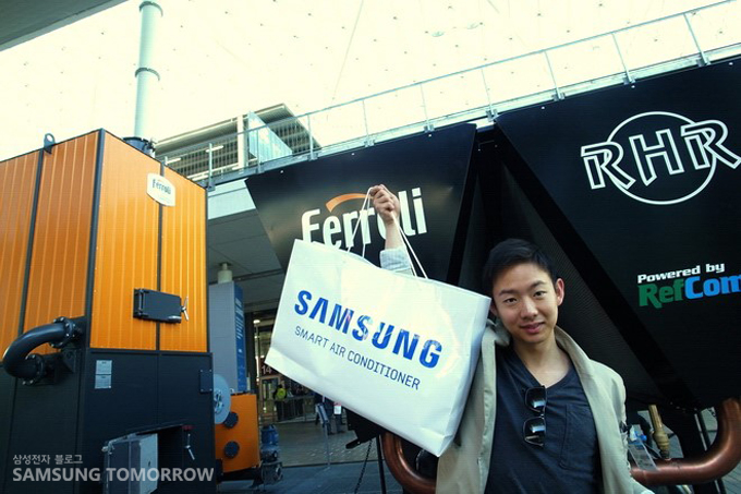 삼성 쇼핑백을 들고 기념사진을 찍는 필자