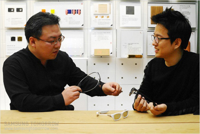 안경을 들고 얘기하고 있는 디자이너와 선임