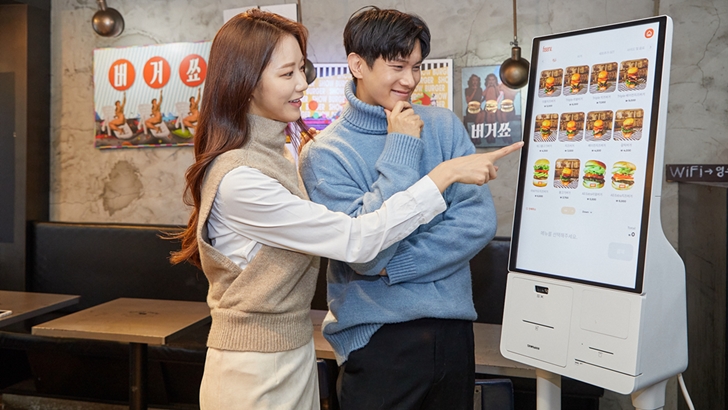 삼성전자 모델이 서울 성동구에 위치한 햄버거 전문점 '버거쇼'에 설치된 신제품 '삼성 키오스크'를 소개하고 있다.