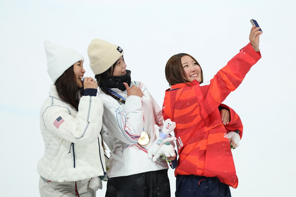 13일(한국시간) 이탈리아 리비뇨 스노파크에서 열린 2026 밀라노·코르티나담페초 동계 올림픽 스키 스노보드 여자 하프파이프 시상식에서 금메달 최가온(대한민국), 은메달 클로이 김(미국), 동메달 요노 미츠키(일본) 선수가 갤럭시 Z 플립7 올림픽 에디션으로 빅토리 셀피를 찍고 있다.
